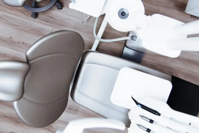 Contemporary dental chair and instruments seen from above