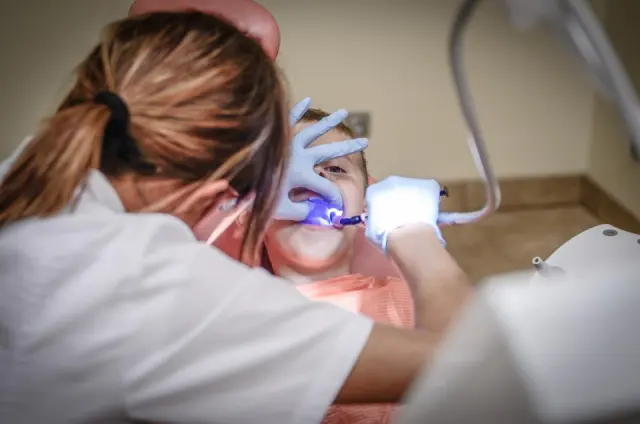 Dentist carefully treating a patient in a modern clinic